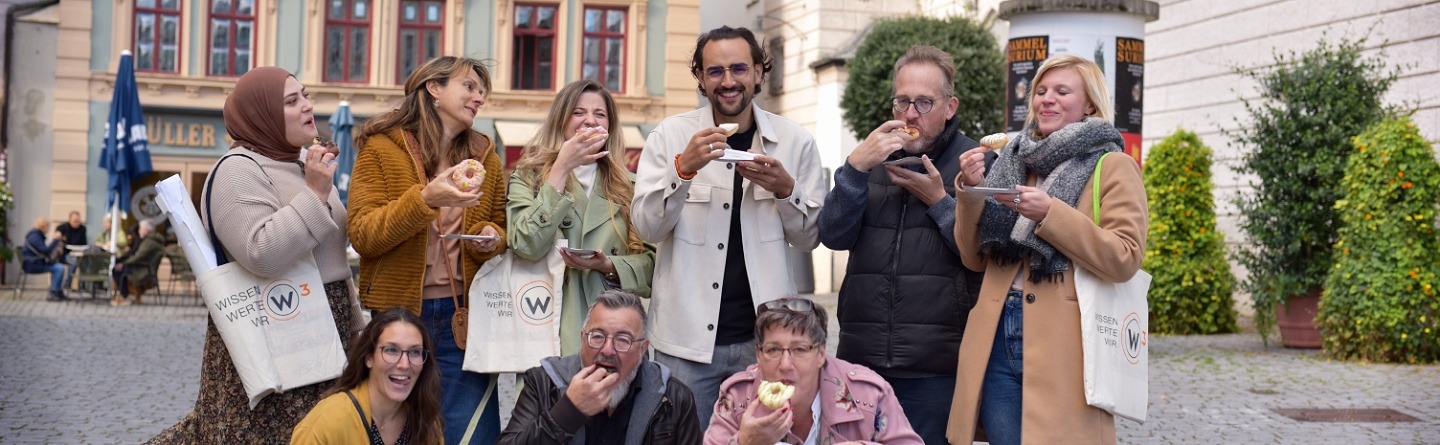 Dieses Gruppenbild zeigt die Mitglieder vom W³-Team, welche mit Abstand und Mund-Nasen-Bedeckung in die Kamera schauen.